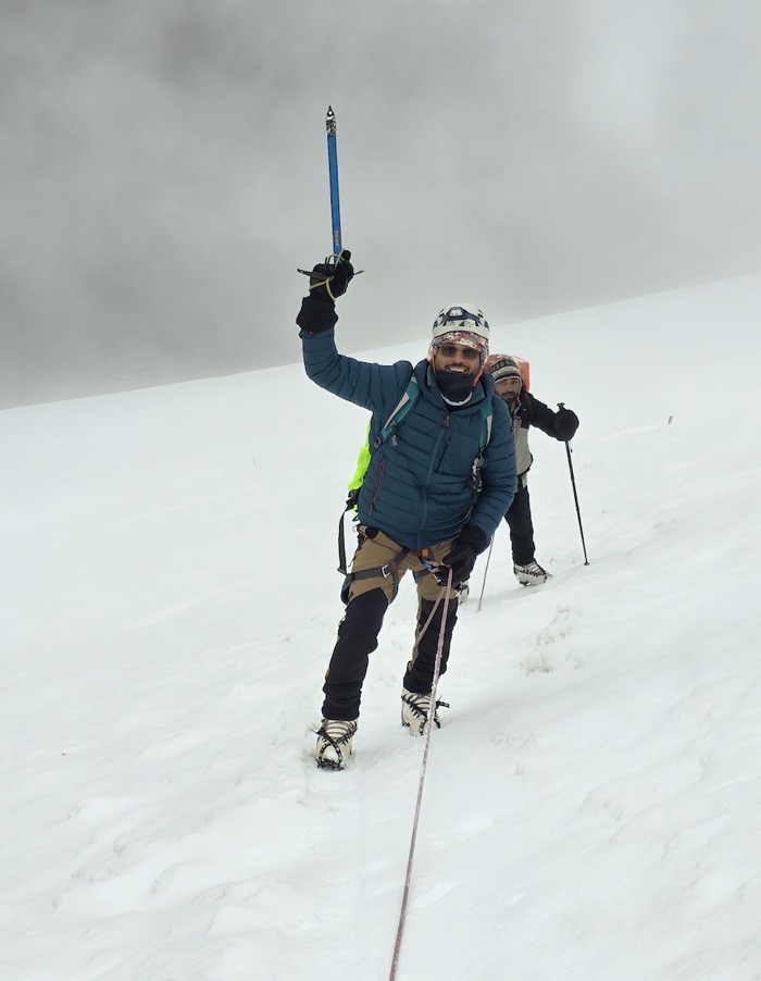Resting on the snowy Kang Yatse II slope around the midpoint of the climb.